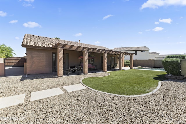 back of property with a pergola, stucco siding, a tile roof, and a patio area