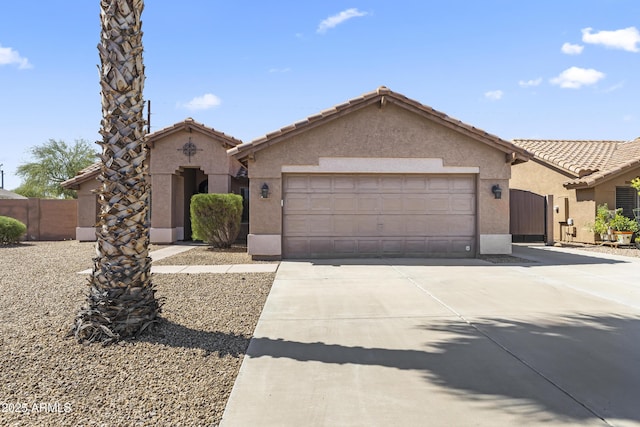 mediterranean / spanish-style home featuring concrete driveway, stucco siding, and an attached garage