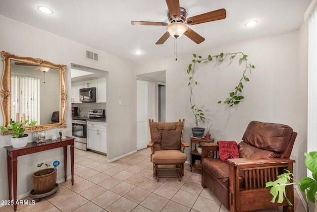 sitting room featuring ceiling fan and light tile patterned floors