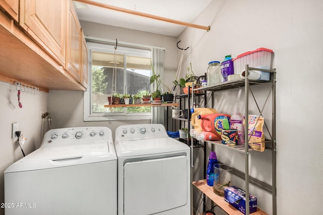 washroom featuring cabinets and washer and dryer