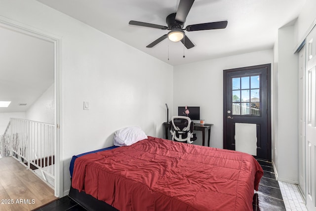 bedroom with ceiling fan and a skylight