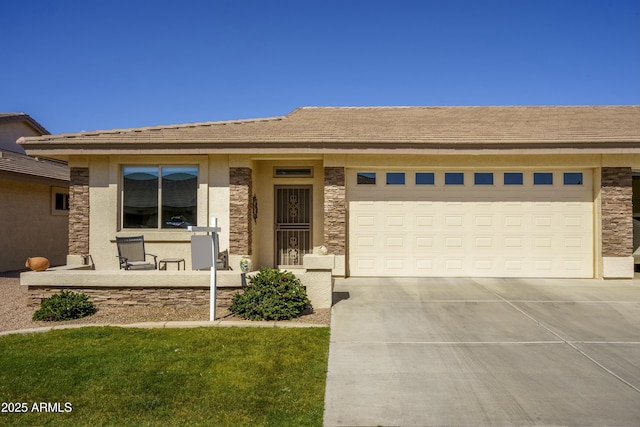 view of front of home with a tile roof, stucco siding, concrete driveway, a garage, and stone siding