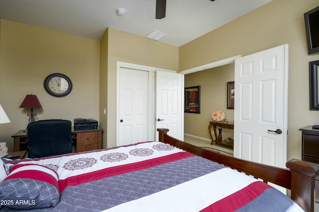 bedroom featuring wood finished floors, visible vents, baseboards, a ceiling fan, and a closet