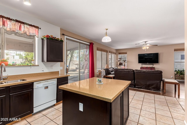 kitchen featuring white dishwasher, sink, plenty of natural light, and a kitchen island