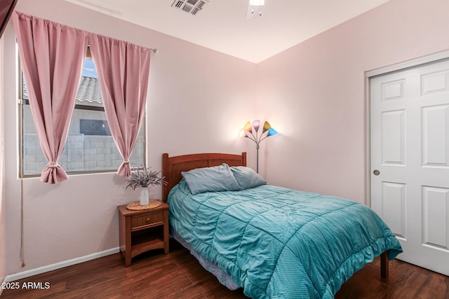 bedroom with a closet and dark hardwood / wood-style flooring