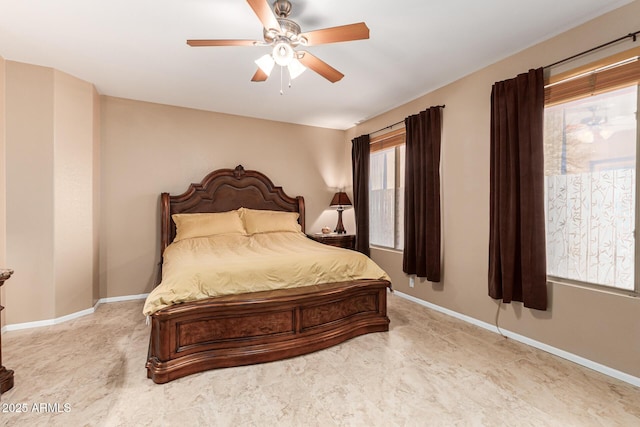 bedroom with ceiling fan and multiple windows