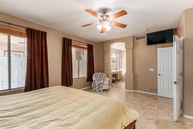 bedroom featuring ceiling fan and ensuite bath