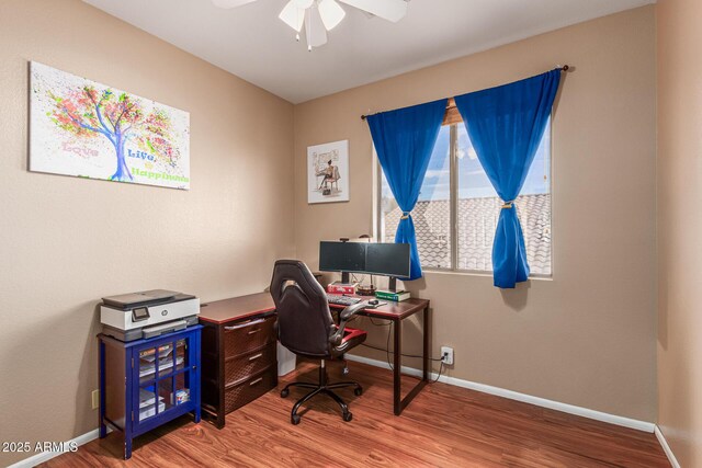 home office with ceiling fan and hardwood / wood-style floors