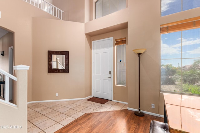 tiled entryway with a towering ceiling