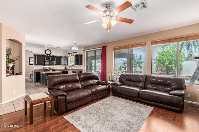 living room with ceiling fan and dark hardwood / wood-style floors