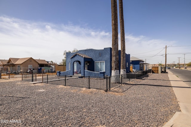 view of front of home with playground community, fence, a residential view, and stucco siding