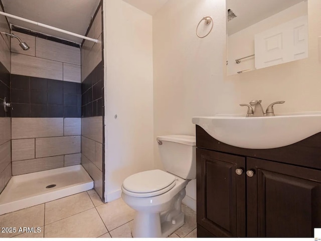 full bathroom with tile patterned flooring, a shower stall, vanity, and toilet