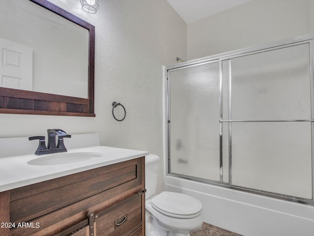 full bathroom featuring vanity, enclosed tub / shower combo, and toilet