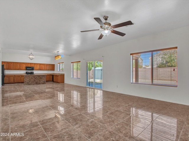 unfurnished living room featuring ceiling fan