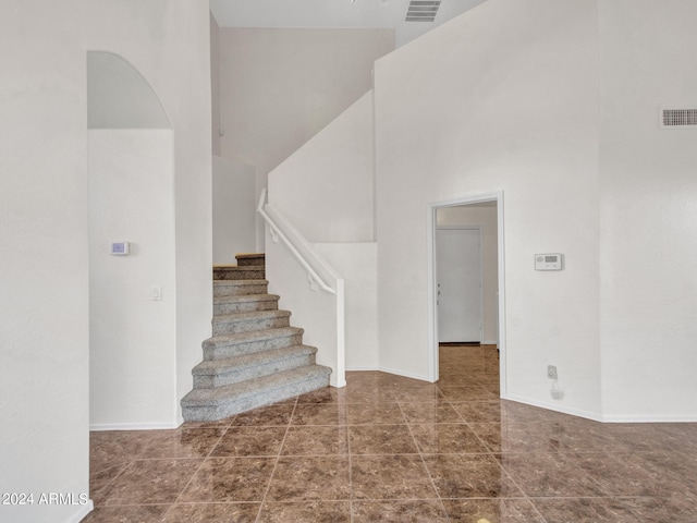 staircase featuring a high ceiling