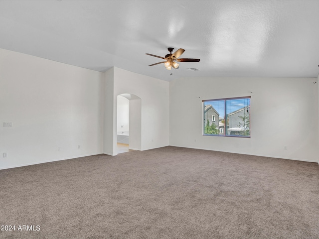 unfurnished room featuring lofted ceiling, carpet floors, and ceiling fan