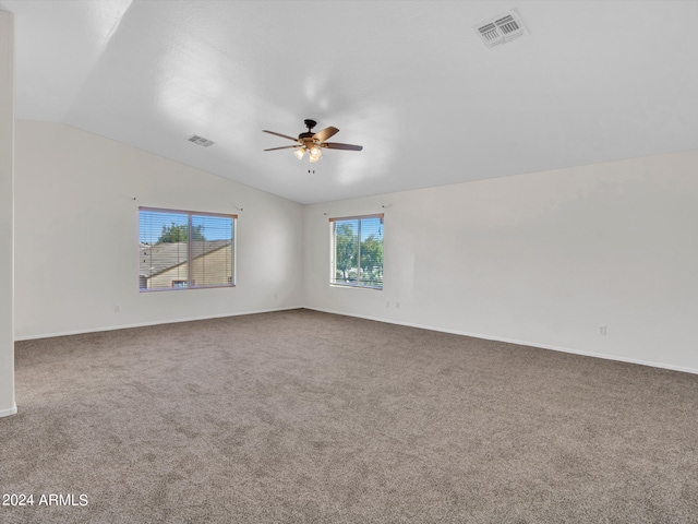 unfurnished room with ceiling fan, carpet flooring, and vaulted ceiling