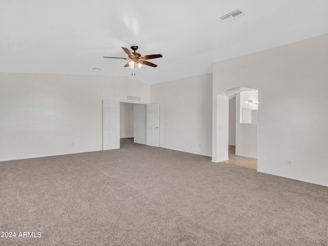 carpeted empty room with ceiling fan and vaulted ceiling