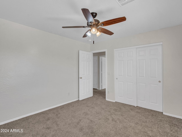 unfurnished bedroom with carpet floors, a closet, and ceiling fan