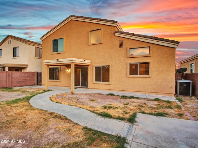 view of front of house with a patio and central AC