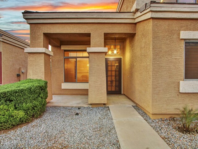 view of exterior entry at dusk