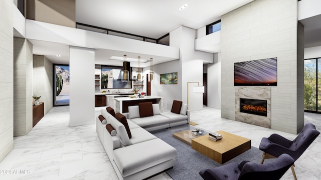 living room featuring a towering ceiling and a tile fireplace