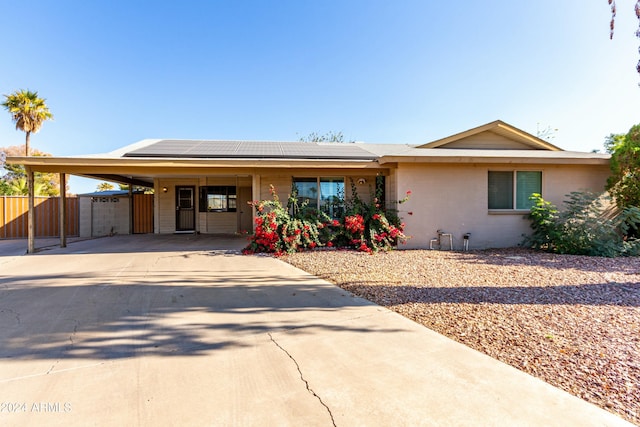 9615 N 34th Ave, Phoenix, AZ 85051 - ranch-style house featuring solar panels, fence, concrete driveway, and a carport