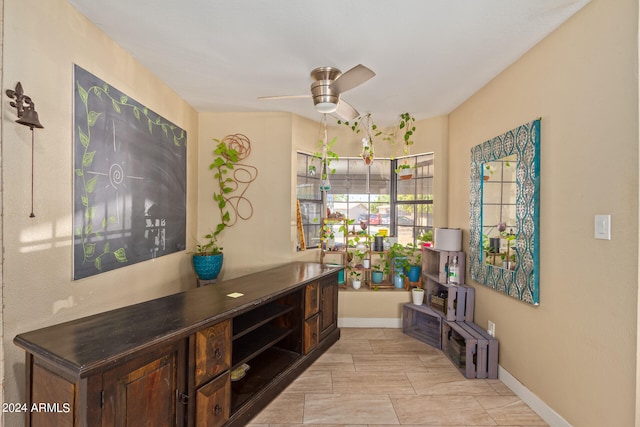 interior space featuring dark brown cabinets and ceiling fan