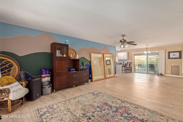 living room with light hardwood / wood-style flooring and ceiling fan