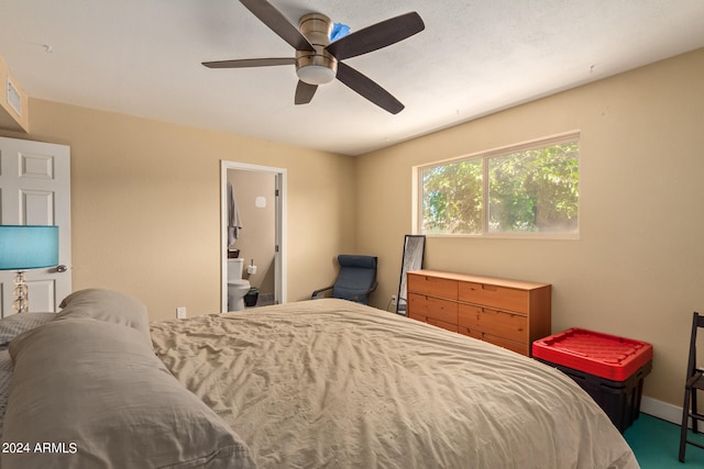 bedroom with carpet flooring, ceiling fan, and ensuite bath