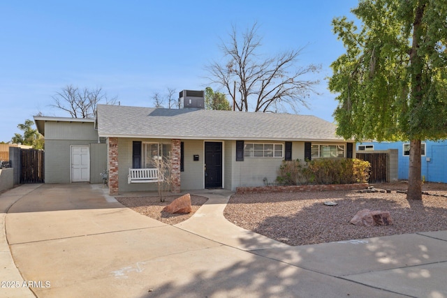 ranch-style house featuring central air condition unit and a porch