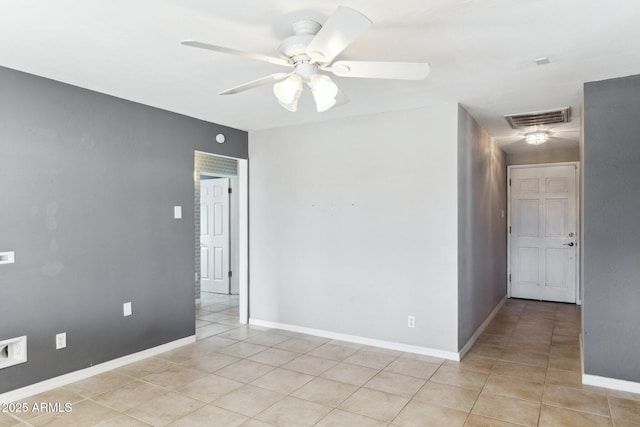 tiled empty room with ceiling fan