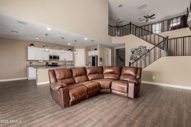 887 W Santa Gertrudis Trl, San Tan Valley, AZ 85143 - living area with baseboards, dark wood-type flooring, ceiling fan, recessed lighting, and stairs