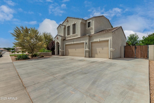 887 W Santa Gertrudis Trl, San Tan Valley, AZ 85143 - view of side of property featuring a gate, concrete driveway, stucco siding, and an attached garage
