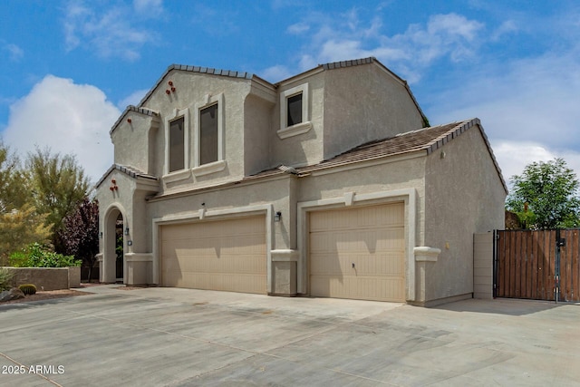 887 W Santa Gertrudis Trl, San Tan Valley, AZ 85143 - view of front of house with a garage, stucco siding, a gate, and driveway