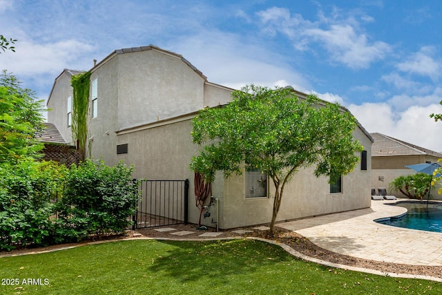 887 W Santa Gertrudis Trl, San Tan Valley, AZ 85143 - back of house with a patio, stucco siding, and an outdoor pool