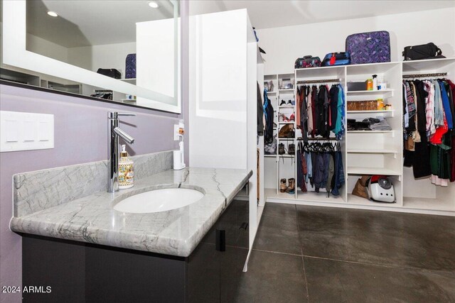 bathroom featuring tile floors and vanity