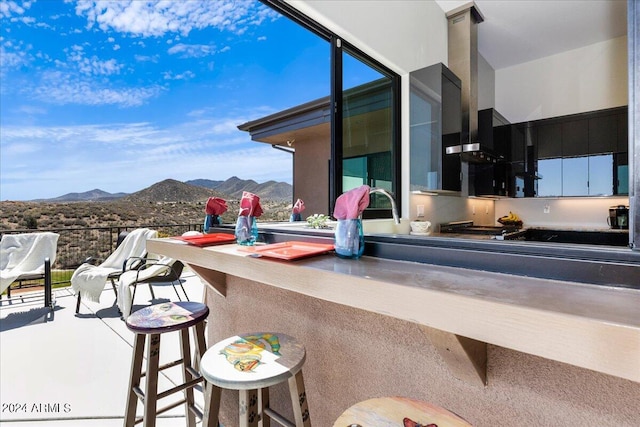 exterior space with a breakfast bar and a mountain view