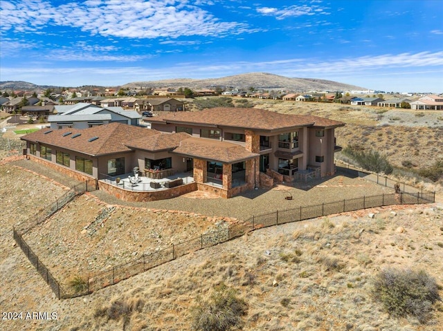 exterior space with a balcony, a patio, and a mountain view