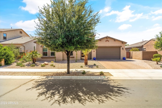 21487 E Arroyo Verde Dr, Queen Creek, AZ 85142 - view of property hidden behind natural elements with a garage, driveway, fence, and stucco siding