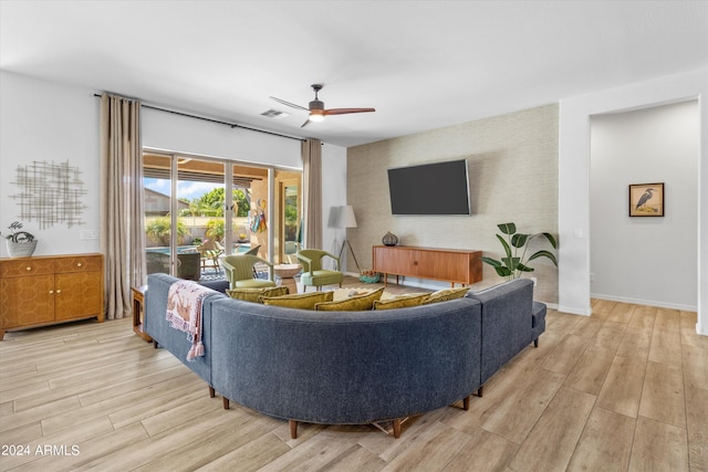 21487 E Arroyo Verde Dr, Queen Creek, AZ 85142 - living area featuring light wood-style flooring, an accent wall, ceiling fan, and visible vents