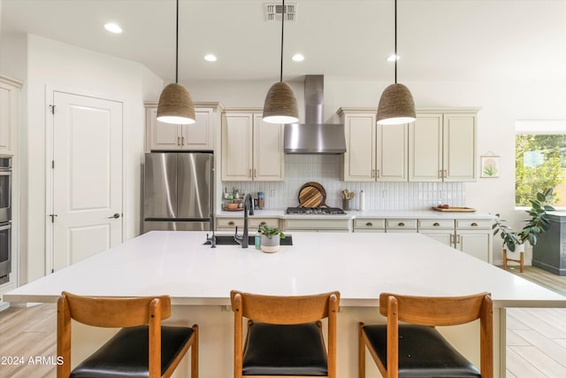21487 E Arroyo Verde Dr, Queen Creek, AZ 85142 - kitchen with wall chimney exhaust hood, visible vents, a sink, stainless steel appliances, and cream cabinets