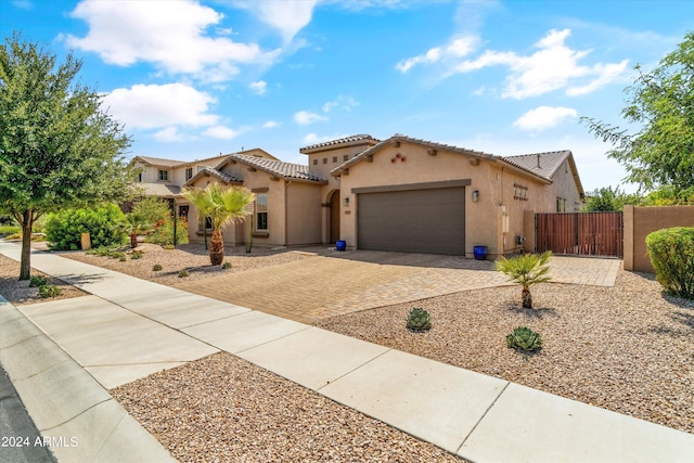 21487 E Arroyo Verde Dr, Queen Creek, AZ 85142 - mediterranean / spanish house with a tiled roof, a garage, stucco siding, a gate, and driveway