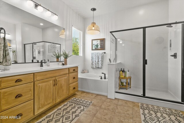 bathroom featuring vanity, shower with separate bathtub, and tile patterned flooring