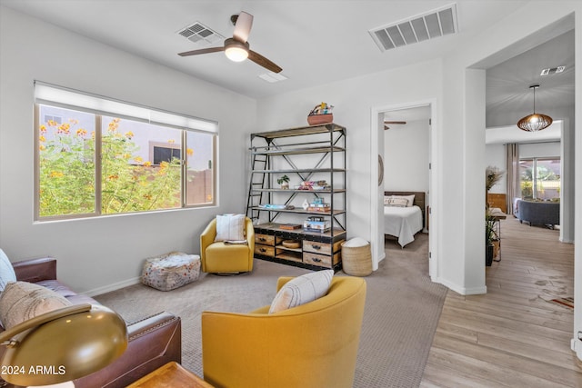 sitting room featuring plenty of natural light, light hardwood / wood-style floors, and ceiling fan