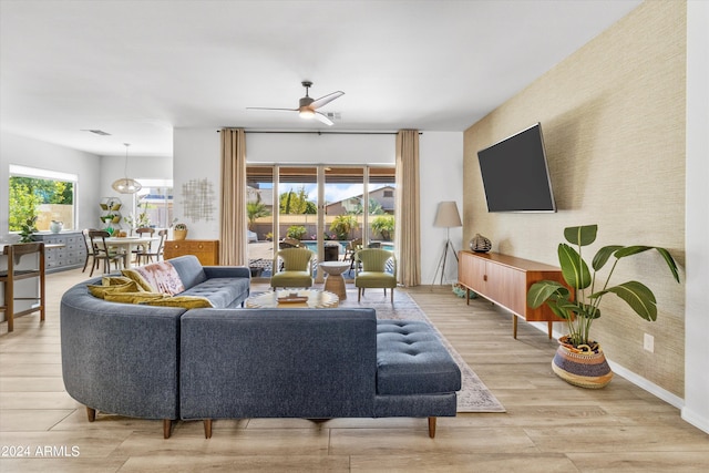 living room with ceiling fan and hardwood / wood-style floors