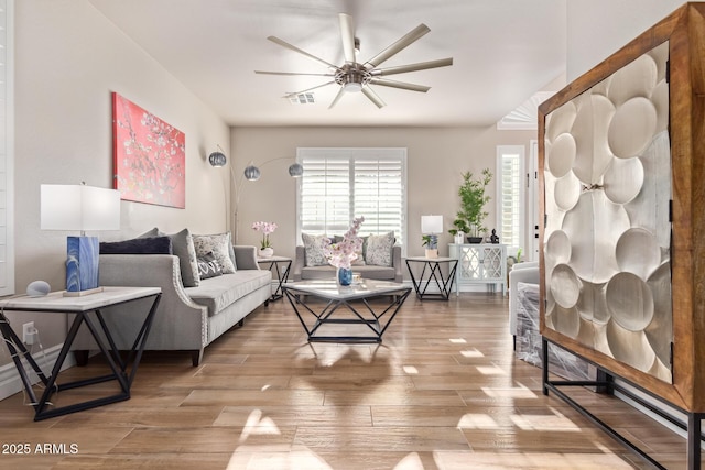 living room with wood-type flooring and ceiling fan