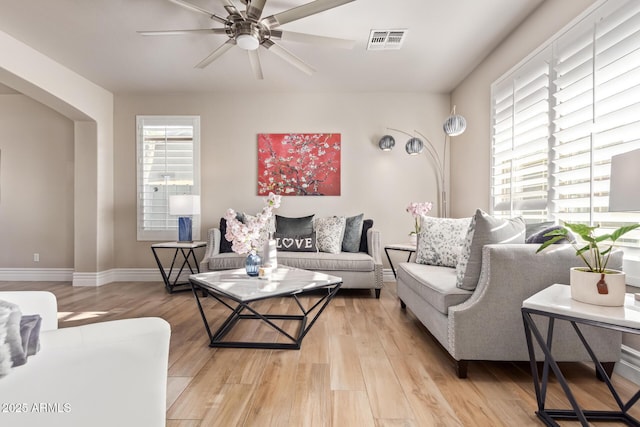 living room with ceiling fan and light hardwood / wood-style floors