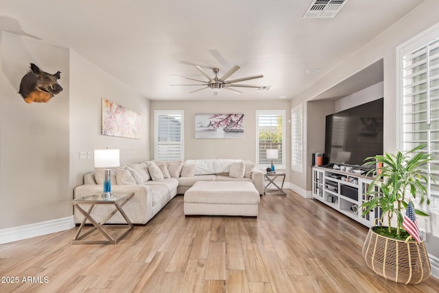 living room with ceiling fan and light hardwood / wood-style flooring