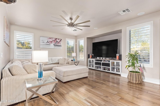 living room with ceiling fan, hardwood / wood-style floors, and a healthy amount of sunlight